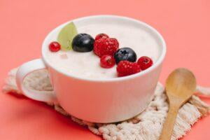 a cup of yogurt with fruit on top